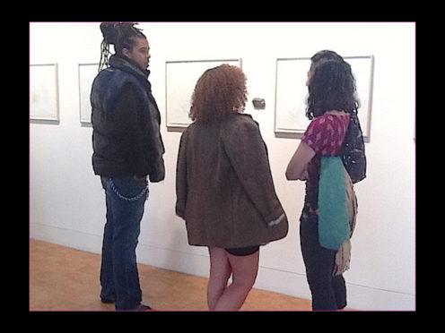 Three people discussing art